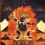 Antique thangka of a wrathful form of Guru Rinpoche wearing a tiger skin holding a vajra and a scorpion surrounded by flames